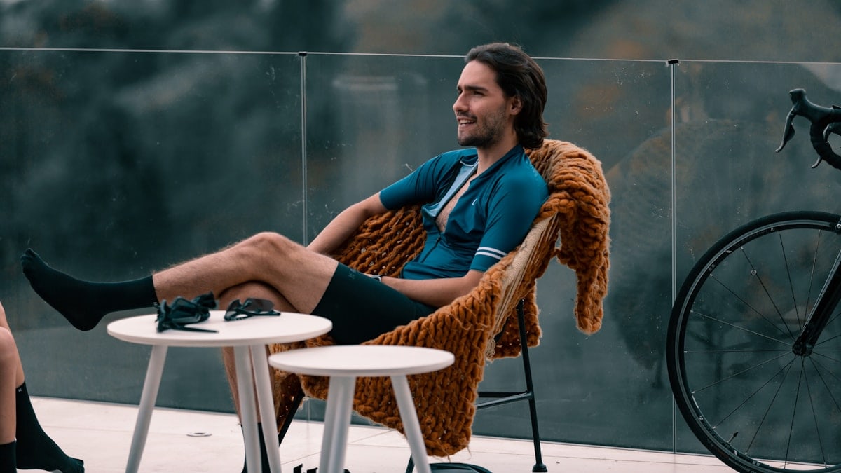 woman in blue long sleeve shirt sitting on brown wicker chair